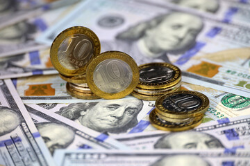 Russian rubles coins on background of US dollars. Concept of exchange rate, american sanctions...