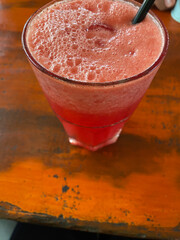 Pink drink with foam and straw refreshment concept for summer, cocktail menu, beverage advertisement, party invitation, tropical vibes, and celebrations.