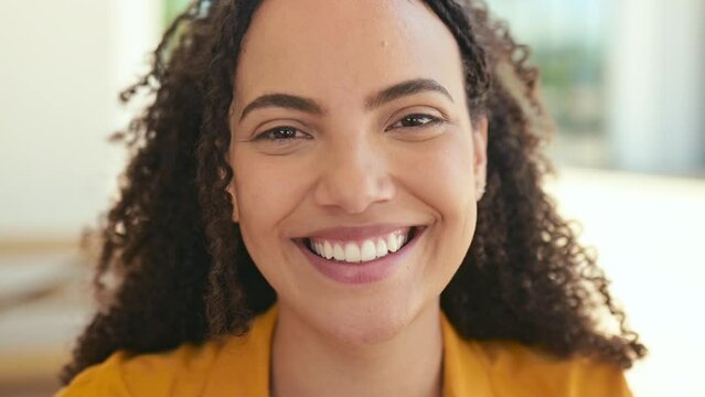 Female student or freelancer. Close-up video portrait of lovely hispanic or brazilian curly haired woman, looking at camera with charming cute toothy smile, posing in casual stylish wear outdoors