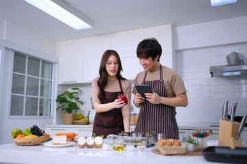 Young couple is livestreaming in kitchen.