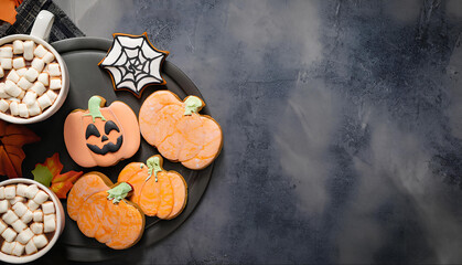 Halloween Decorated Cookies with Marshmellows and hot Chocolate and Leaves for Background with Space for Copy