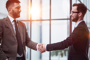 director of the company, glad to meet his new colleague. Handshake and new employee concept.