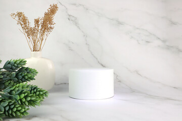 cylinder podium or display stand, white vase with dry branch and green leaf plant. Luxury minimal marble  wall scene mockup product display. Abstract geometric platforms. Round stage for showcase
