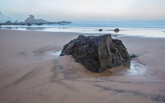 Misty morning at a rocky beach (Praia do Castelejo) at the Atlantic southwest coast of Portugal
