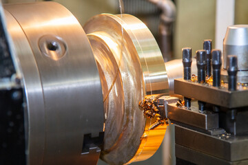 Closeup scene the lathe machine finish cut the brass parts by lathe tools.