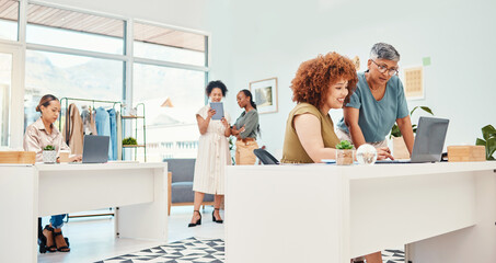 Fototapeta premium Designer group, workshop and fashion startup with computer, talking and planning with ideas, creativity or goals. Women, company and teamwork with fabric, clothes and support for vision in Cape Town