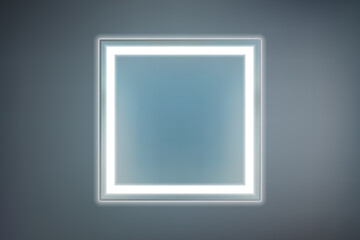 Square mirror with white LED lighting on a dark background. Original piece of furniture with modern lighting