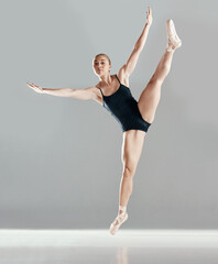 Obraz premium Balance, ballerina or girl in studio on mockup space for wellness, fitness or creative performance. Art, dancer or woman ballet dancing or training to exercise in practice motion on white background