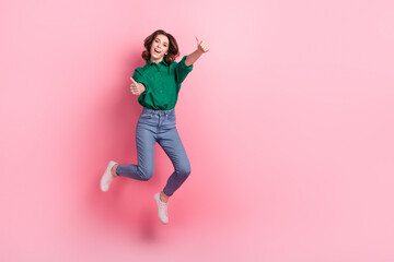 Full length photo of crazy active person jumping hands fingers demonstrate thumb up empty space...