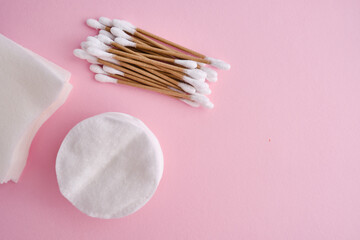 Bamboo cotton buds and cotton pads on a colored background. Biodegradable ear plugs. Eco product