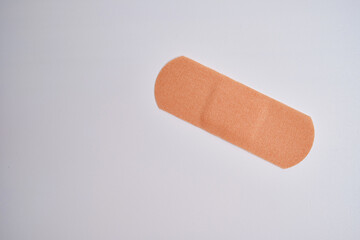 Medical plaster on a red background. Blood donation, space for text. Health and medicine concept
