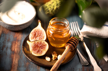 Delicious Greek honey from Rhodes with figs and bowl of yogurt
