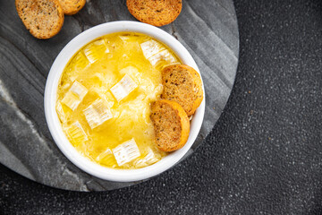 baked cheese camembert, brie or tartiflette soft cheese ready to eat healthy appetizer meal food snack on the table copy space food background rustic top view