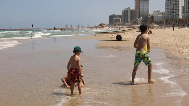 Child, boy, playing on the beach in Tel Aviv in the evening, summertime