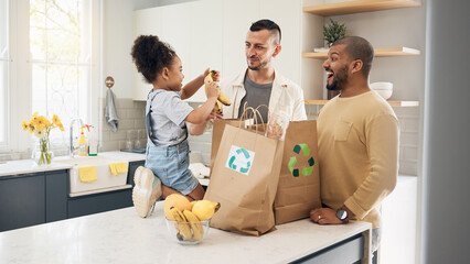 Recycling, blended family or adoption with a girl and gay couple in the home kitchen for sustainability. LGBT, eco friendly or waste with a daughter and parents unpacking bananas from a grocery bag
