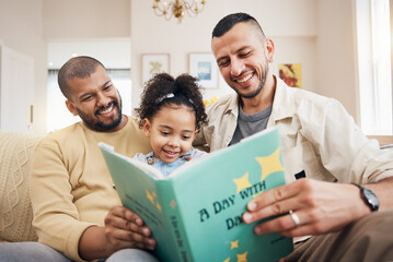 Obraz premium Gay couple, kid and book on couch with smile, bonding and love in storytelling in living room together. Happiness, lgbt men and girl reading story on sofa for fantasy, learning and education in home.