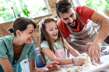 Family makes a cookie in the kitchen