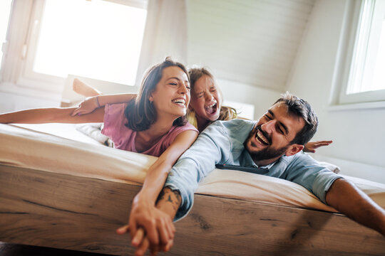 Family have fun in bedroom
