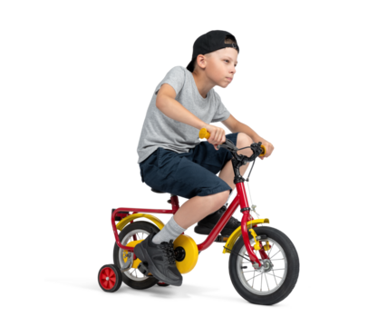 A teenage boy, in a cap, T-shirt, shorts, excitedly rides a children's bike, isolated on a transparent background png.