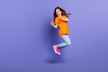 Fototapeta na wymiar Full body size photo of crazy jump overjoyed schoolgirl having fun positive mood wear trendy garment isolated on violet color background