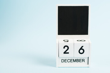 Boxing Day, wooden calendar with date December 26 on blue background with copy space. The concept of preparing for the celebration of Christmas and New Year and plans for the future.