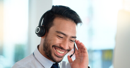 Call center agent consulting a buyer via video call in an office. A young friendly sales man...