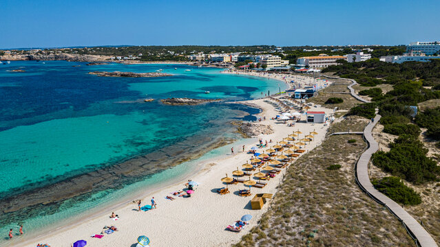 Aerial of the turquoise waters and white sand beach of the Pujols beach, Formentera, Balearic Islands, Spain, Mediterranean