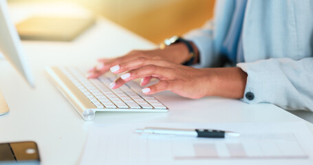 Closeup of a womans hands typing on a keyboard while sitting at a desk and sending an email in an office. Financial advisor doing online research for a budget plan and communicating with clients