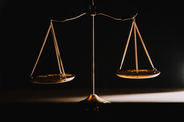 Business and lawyers discussing contract papers with brass scale on desk in office. Law, legal services, advice, justice and law concept picture with film grain effect