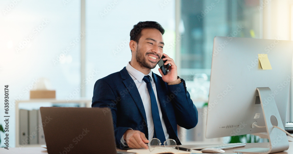 Fototapete happy business man talking on his phone while working on a computer and smiling alone at work. young