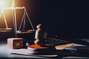 law legal technology concept. judge gavel on computer with scales of justice on desk of lawyer.
