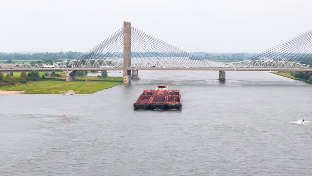 Aerial view of a cargo barge sailing on the river Waal in the Netherlands