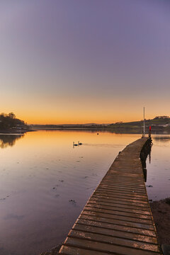 A very calm dusk scene, with a wooden jetty on the estuary of the River Teign, at Coombe Cellars, near Newton Abbot, south coast of Devon, England, United Kingdom