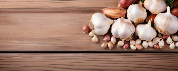 Fototapeta na wymiar Garlic on wooden board background, text copy space