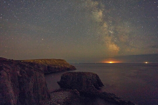 An autumn view of the Milky Way over the Atlantic Ocean, seen from the cliffs of Land's End, the most southwesterly point of Great Britain, Cornwall, England, United Kingdom