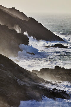 Atlantic cliffs pounded by surf and spray during stormy winter weather, at Pendeen, near S.t Just, in the far west of Cornwall, England, United Kingdom