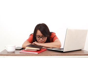 Tired young asian entrepreneur woman sleeping on the desk. Isolated on white background