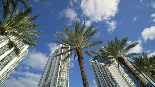 Low angle view of luxurious highrise hotels and condos on Atlantic ocean shore in Sunny Isles Beach city. American tourism infrastructure in southern Florida