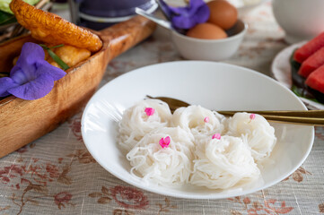 Thai rice noodles or Kanom Jeen in dish on table