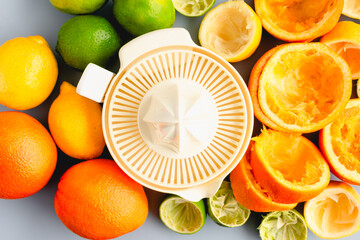 Electric Juicer Surrounded by Citrus Fruit Viewed from Above: An electric juicer surrounded with...