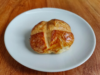 plain patisserie pogaca on a white plate, traditional Turkish pastry