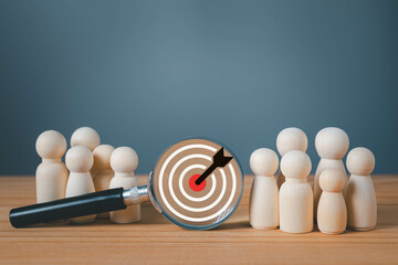 Target and goal expansion concept, Wooden figures standing around dartboard and arrow for creative and set up business objective target goal, marketing solution, target for business investment.