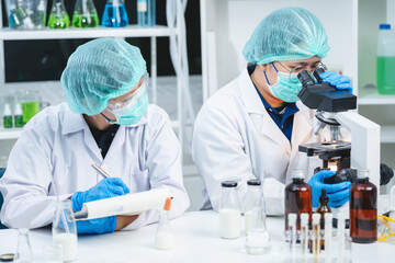 Food scientist testing new stuff samples of dairy products in the laboratory, female laboratory...