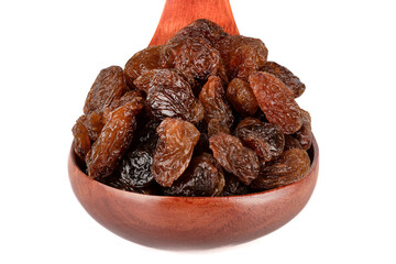 Wooden spoon full of sweet raisins on a white background.
