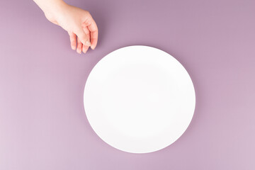 a female hand reaches over to pick up an empty plate. Advertising space