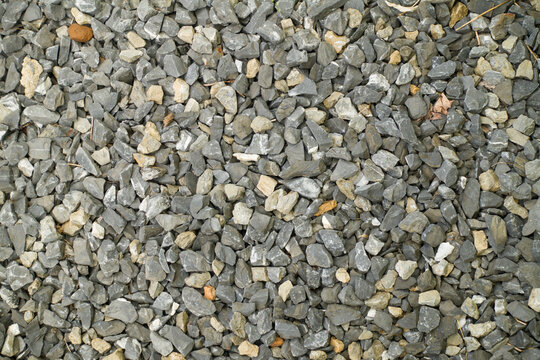 Various crushed rocks cover an entire frame of a photo. Nature, construction, background themes, and concepts.