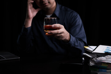 Closeup businessmen holding a glass of whiskey