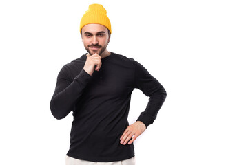 portrait of a smart young 30s authentic brunette male adult with a beard in a black sweater on a white background with copy space