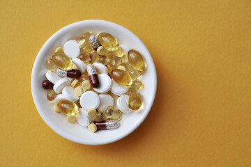 Medical background with pills, pills, vitamins in a white cup