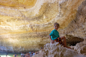 Children, enjoying Benagil, Portugal. Benagil Cave inside Algar de Benagil, famous sea cave in...